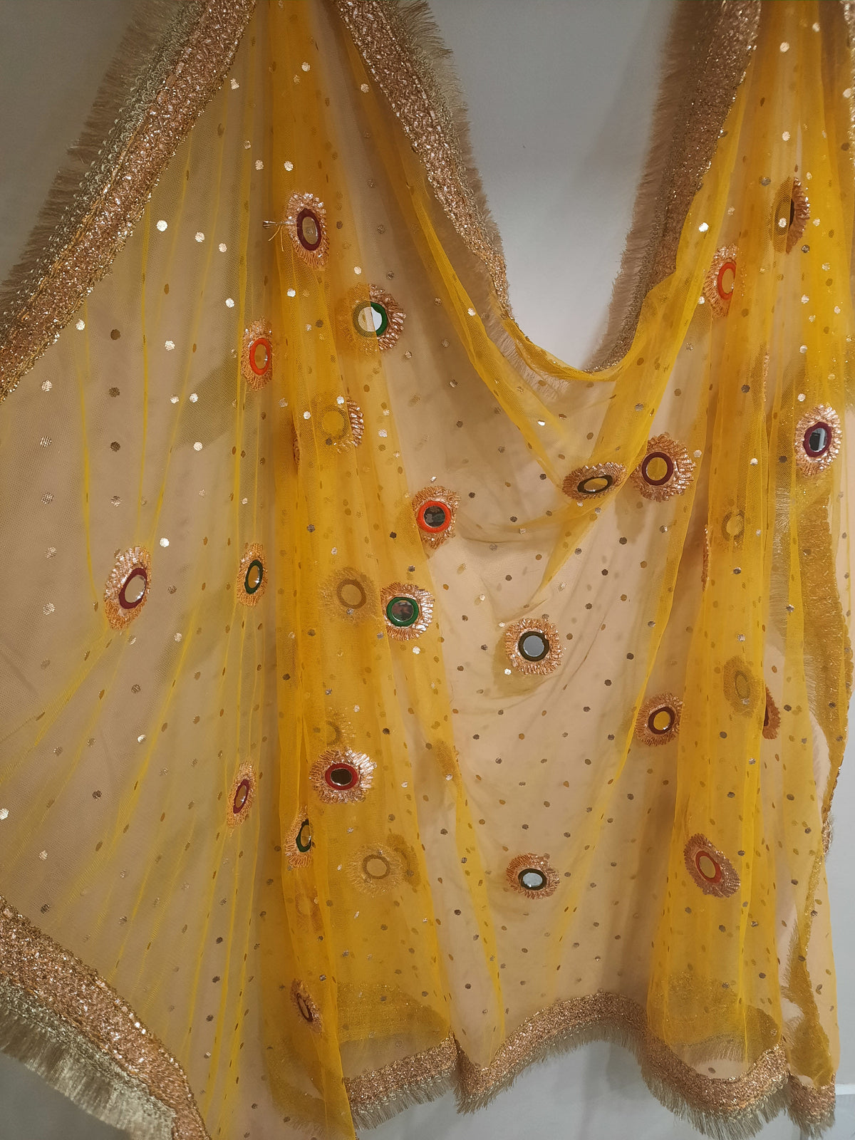 yellow net dupatta with phulkari-style mirror work embroidery