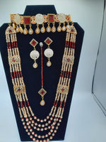 Bridal Jewelry in Golden base with maroon precious stones