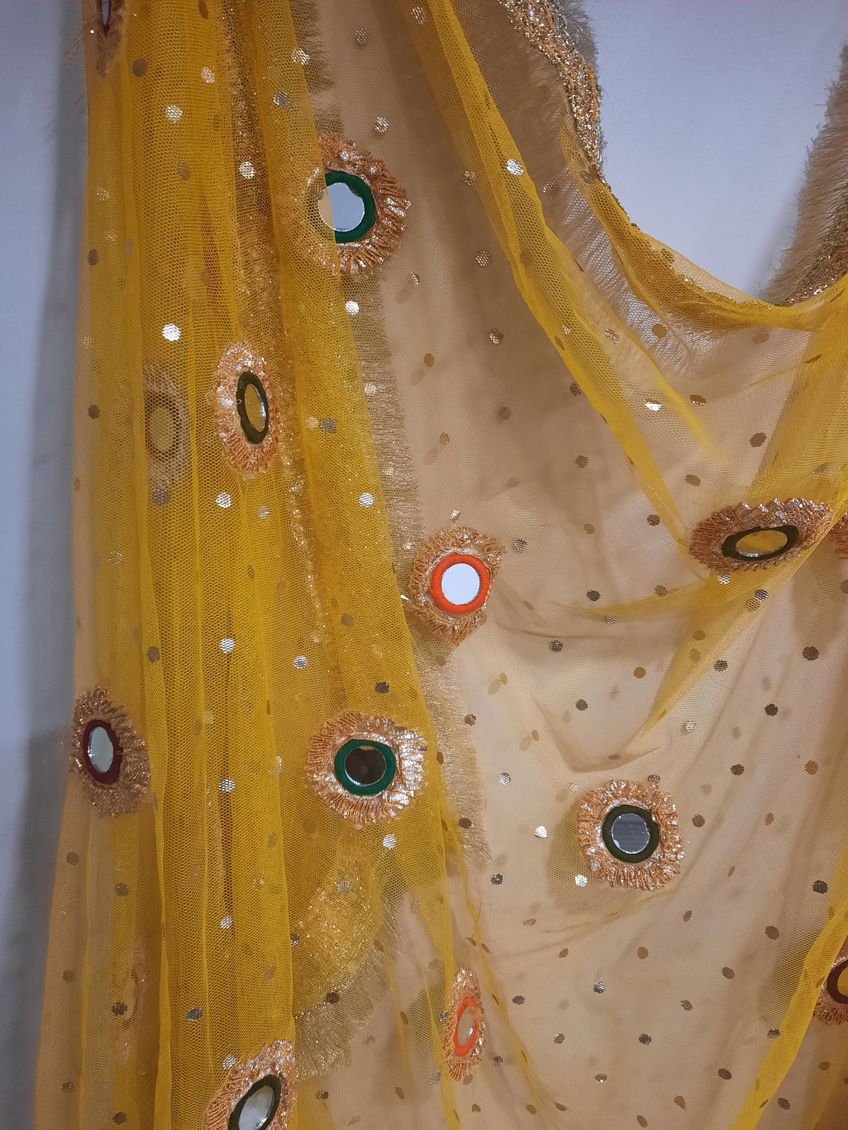 yellow net dupatta with phulkari-style mirror work embroidery