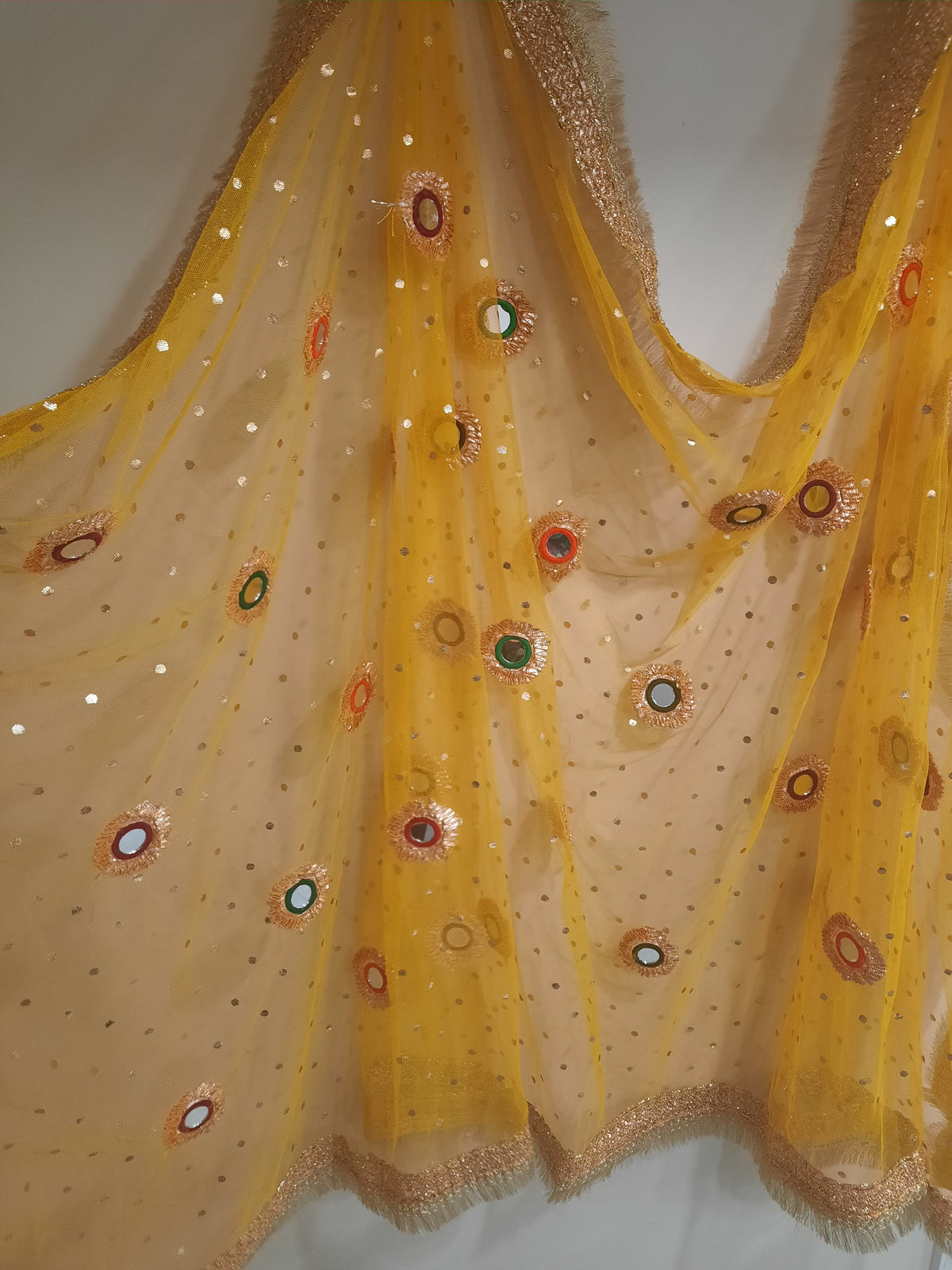 yellow net dupatta with phulkari-style mirror work embroidery
