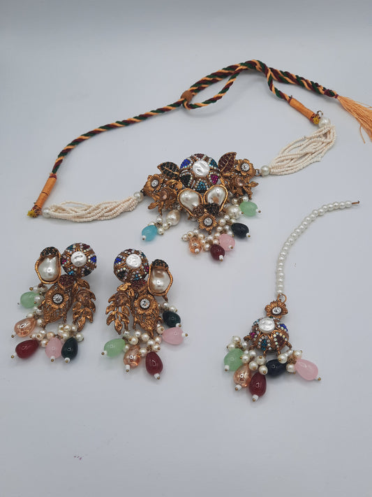 Turkish-style multi-color stone and pearl choker set with matching earrings and a maang tikka.