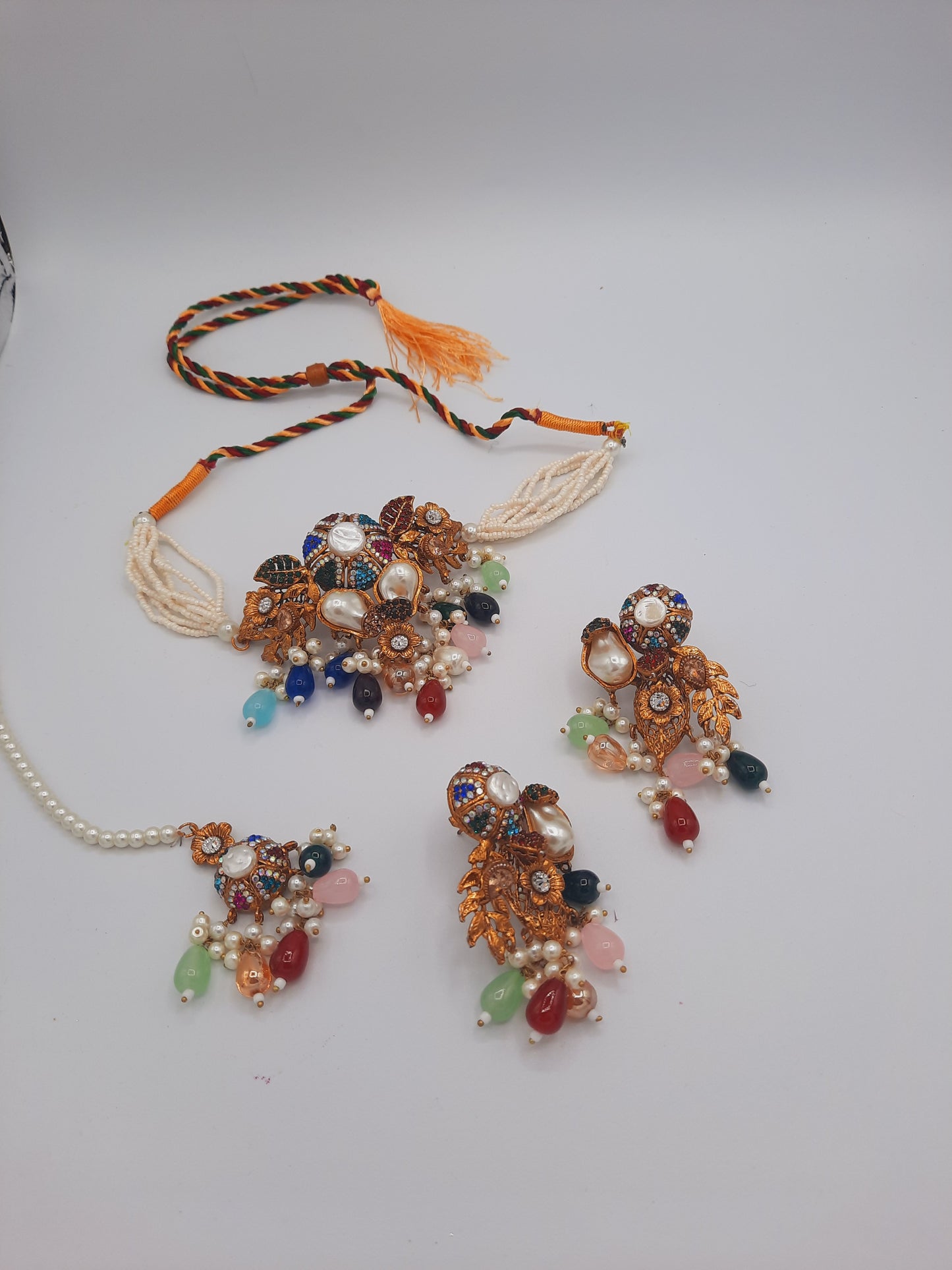 Turkish-style multi-color stone and pearl choker set with matching earrings and a maang tikka.