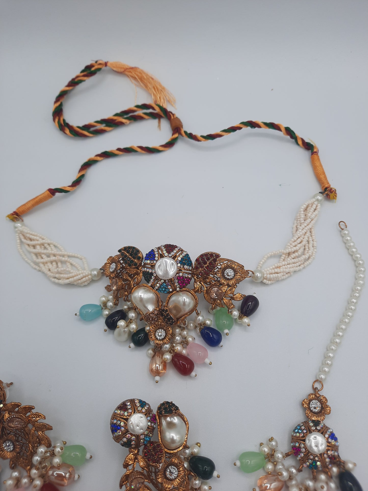 Turkish-style multi-color stone and pearl choker set with matching earrings and a maang tikka.