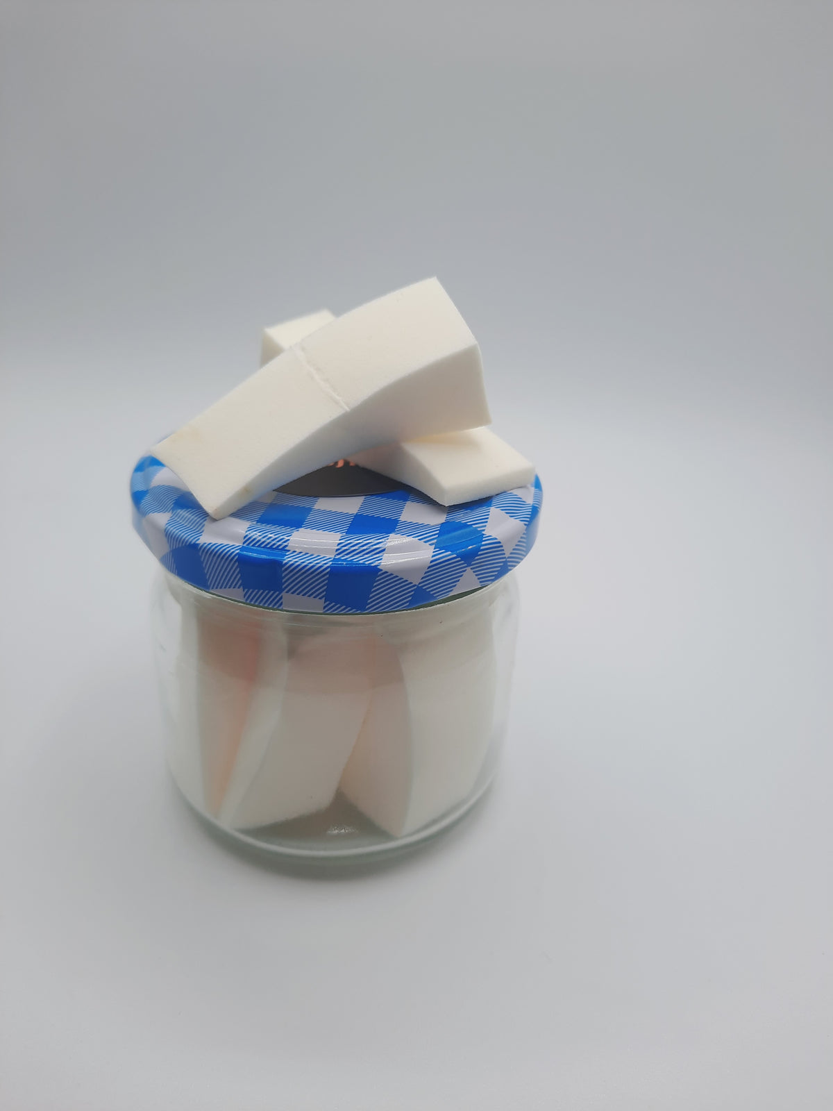 Makeup sponge in glass container approx 10 pieces