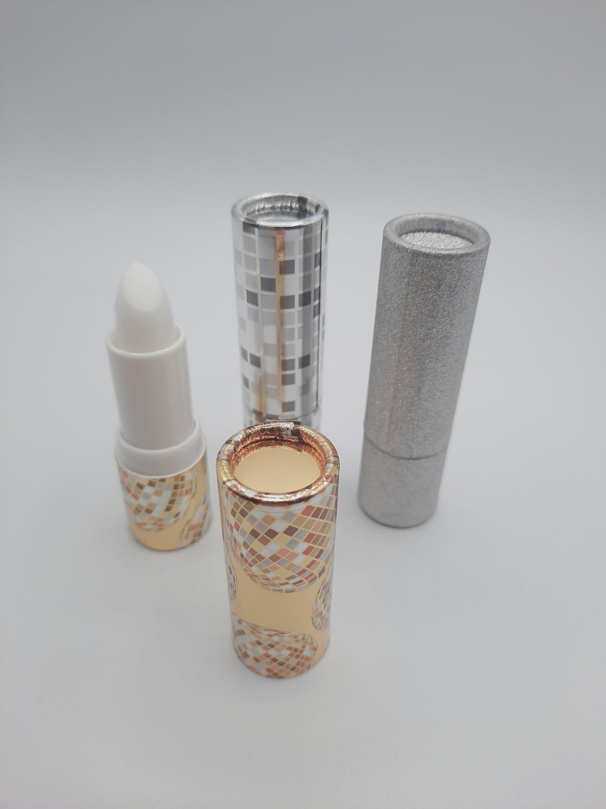 Nicole  Emiller Lip Lift balm treatments alongside their decorative packaging tubes