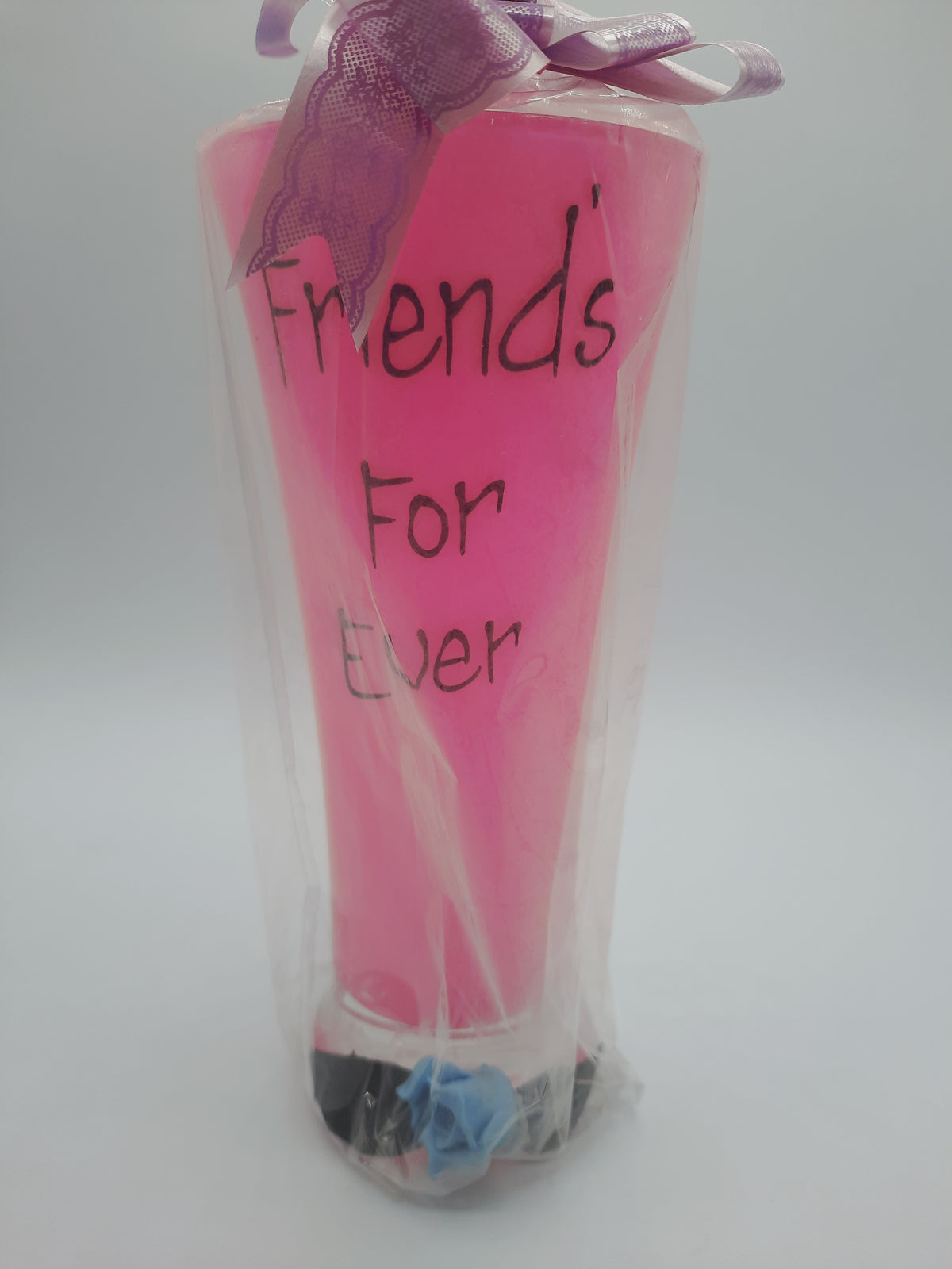 A sentimental, gift-wrapped "Friends For Ever" novelty pink pilsner glass or vase keepsake