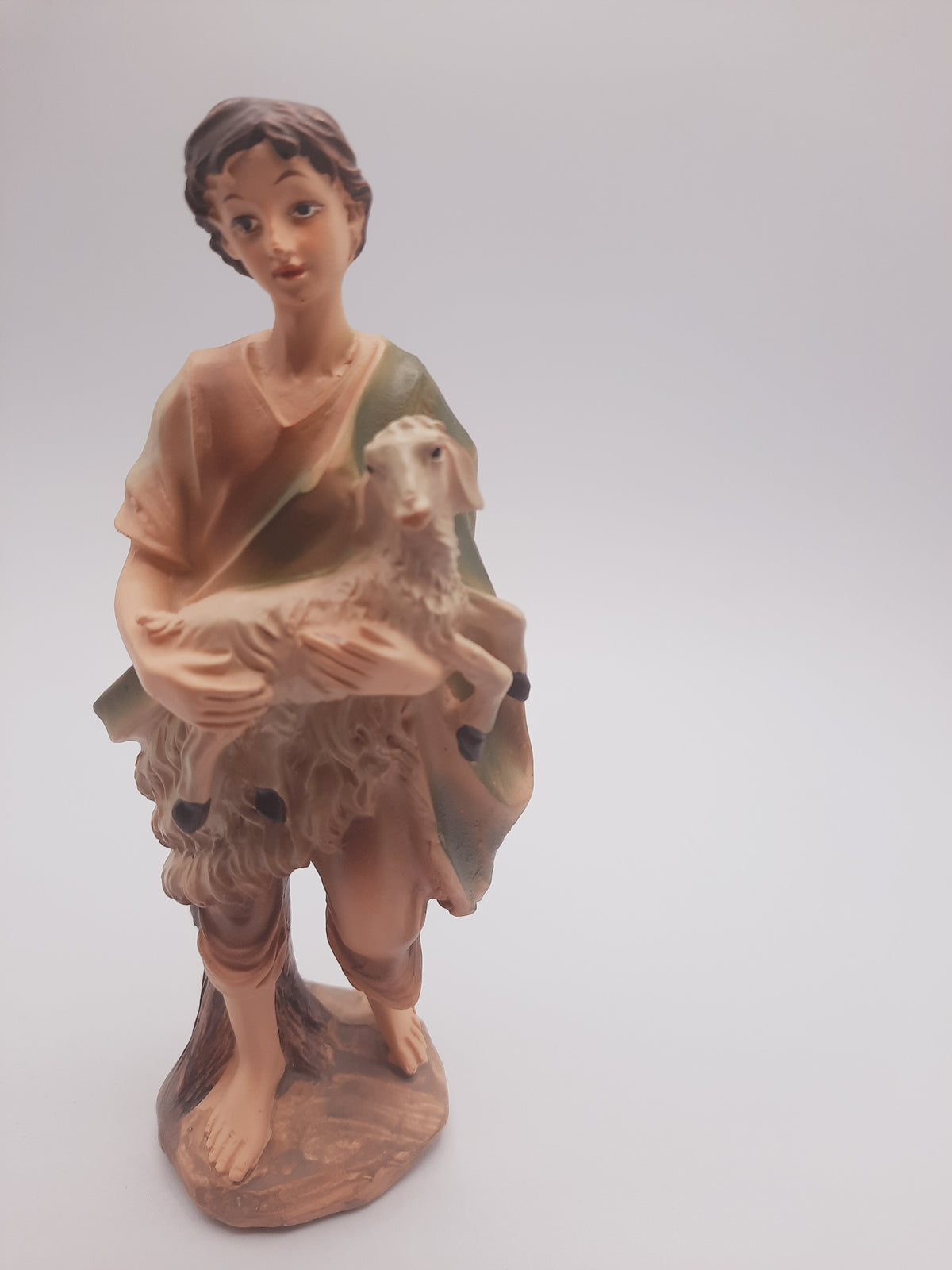 Shepherd Boy holding a lamb figurine, which is a classic supplementary figure nativity crèche collection