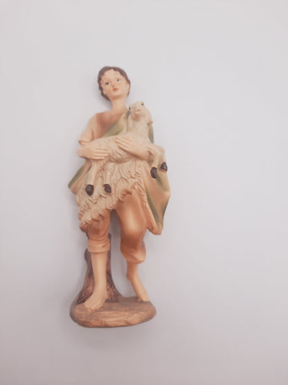 Shepherd Boy holding a lamb figurine, which is a classic supplementary figure nativity crèche collection